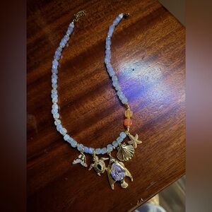 New. Never worn. Gold and Blue Charm Necklace